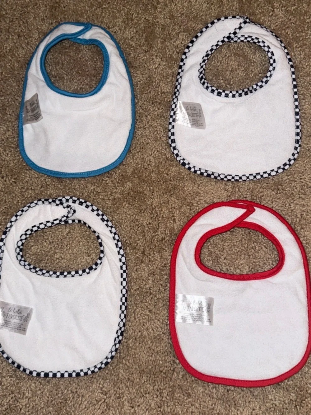 4 baby bibs with embroidered text and graphics